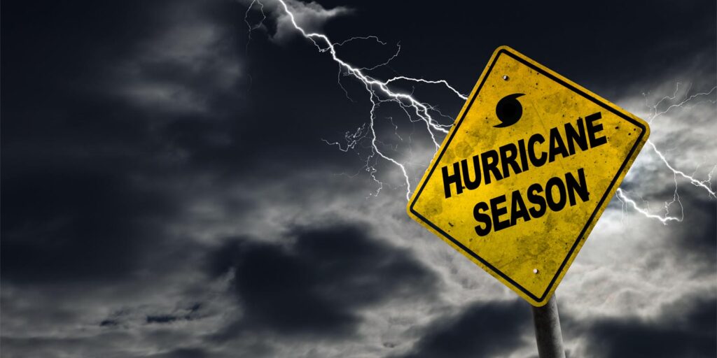 a road sign indicating a warning for hurricane season