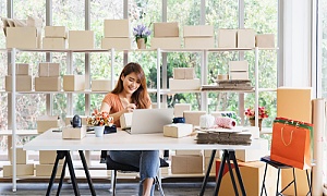 a women sitting at her work desk doing an inventory audit