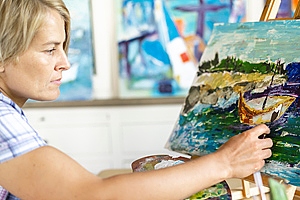 Blonde Woman Painting Boat on rive