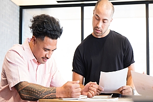 Two employees looking at a document together