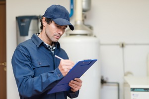 technician servicing an hot water heater