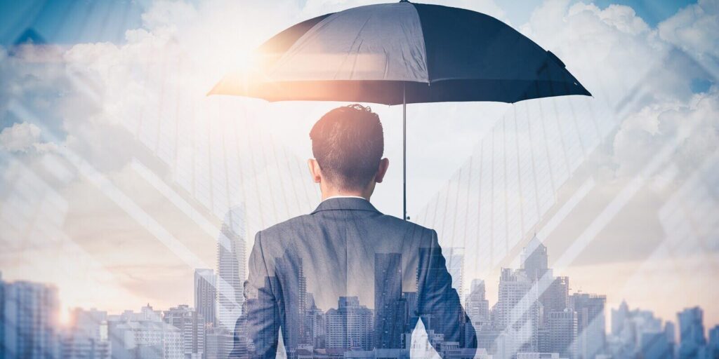 double exposure image of the Businessmen are spreading umbrella during sunrise overlay with cityscape image