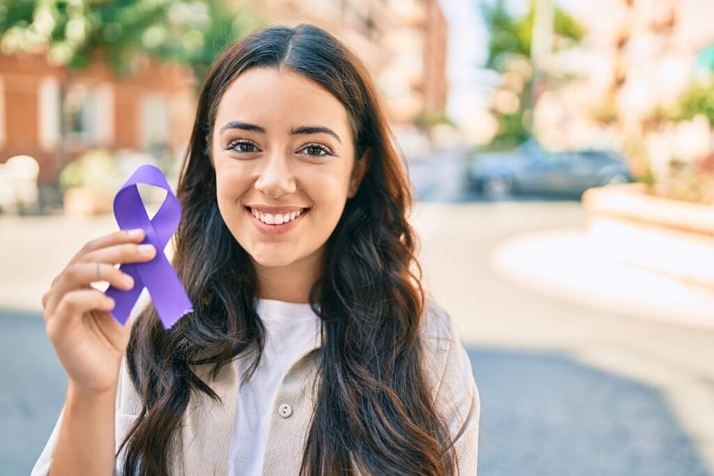 young woman holding a purple pendant representing alzheimers