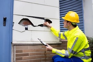 man inspecting damage caused by flood