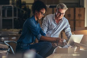 two young business owners reviewing their business insurance options