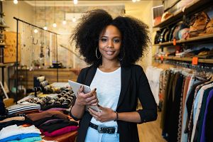 young business owner of a clothing store reviewing business liability insurance