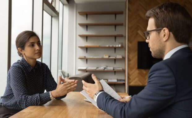 man professional lawyer counsel give advice propose decision to serious indian woman customer at private office