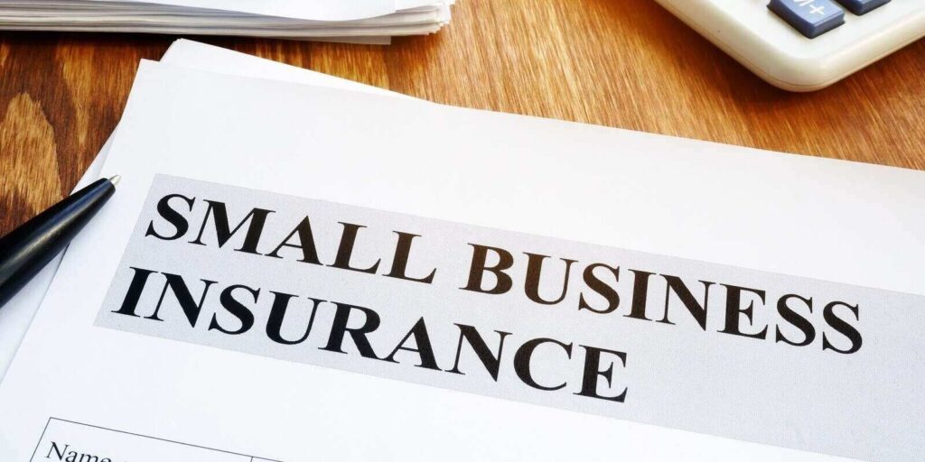 small business insurance policy on a wooden desk