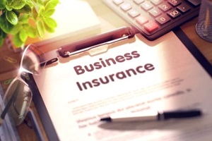 business insurance text on clipboard
