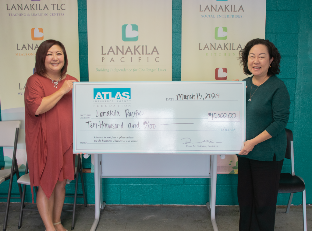 This is a photo of Atlas Insurance donating a large check to Lanakila Pacific