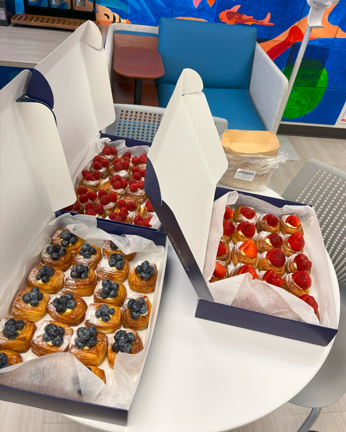 this is a picture of several Paris Baguette fruit pastries inside three boxes