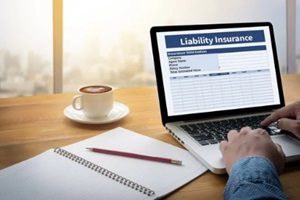 man filling liability insurance form on laptop