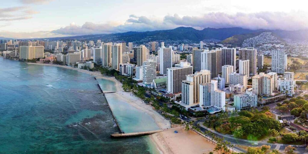 sunrise panoramic view of the densest parts of honolulu at waikiki and its beach and hotels