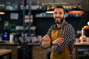 bartender wearing apron and smiling