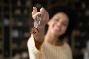 close up focus on keys in hands of smiling young African American woman