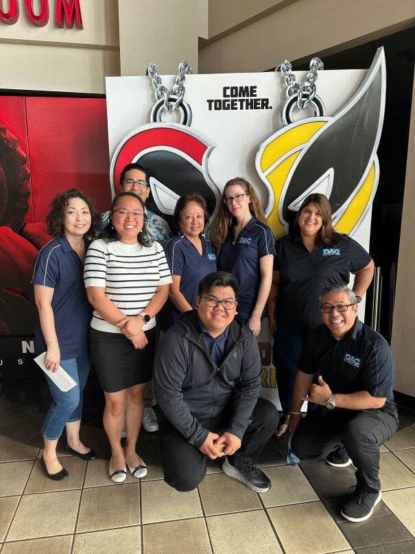 this is a picture of Atlas Insurance employees at Movie Day with Deadpool and Wolverine