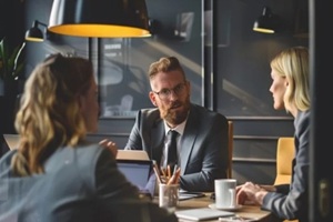 Hawaio business manager and an employee sitting across from each other in a private office