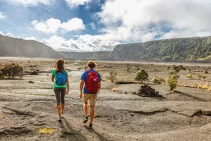 couple tourists hikers walking on kilauea iki crater trail hike in big island, hawaii