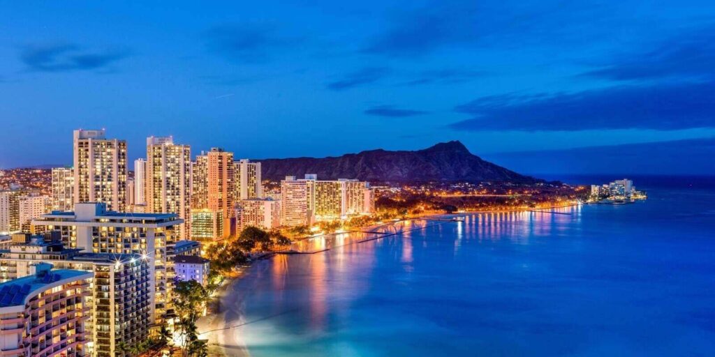 waikiki beach and diamond head volcano next to hawaii businesses