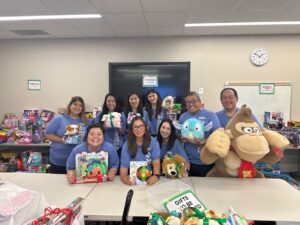 this is Atlas employees at Kapiolani Medical Center's Santa's Workshop Volunteering Event