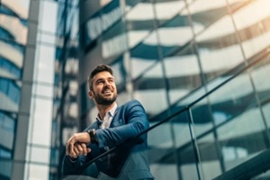 smiling business man outside big office building in Hawaii