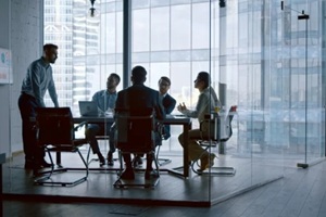 business people listening the presenter while sitting at desk