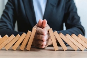 risk and strategy in business hand stopping wooden block domino business crisis effect or risk protection concept business solution and intervention