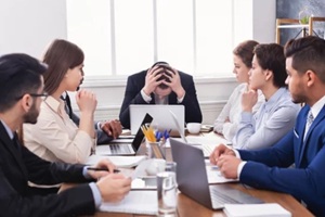 stressed boss having problem at business meeting in office