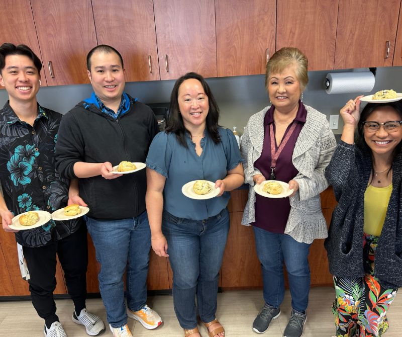 This is a photo of Atlas employees enjoying scones from Sconees Bakery