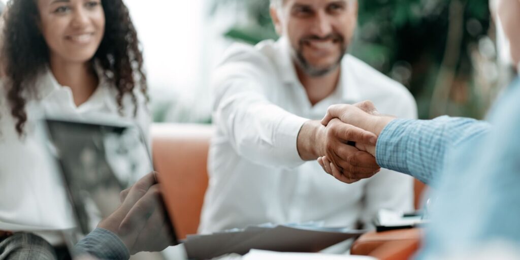 smiling businessman shaking hands with his Hawaii business insurance agent