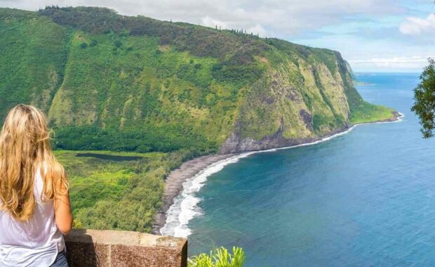 young woman enjoying the amazing view in Waipio Valley, Big Island, Hawaii