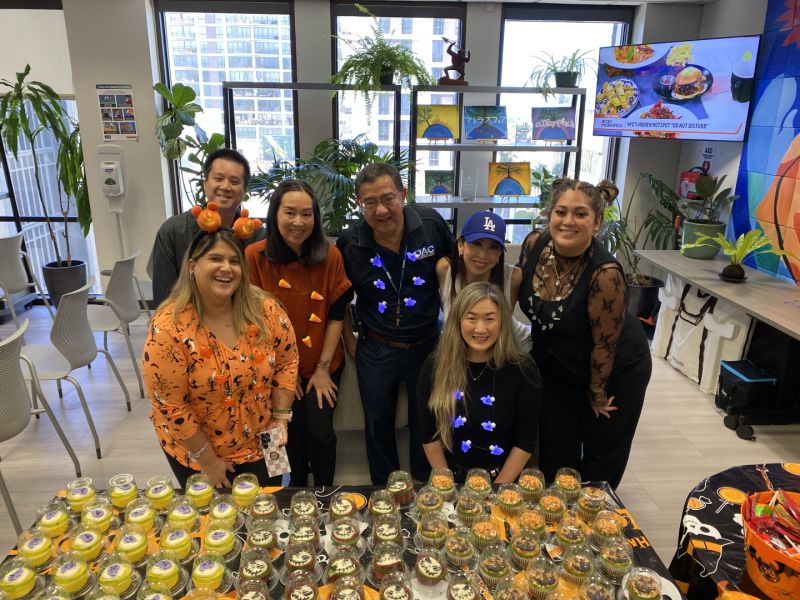 Smiling Atlas Insurance Employees at a company Halloween Celebration