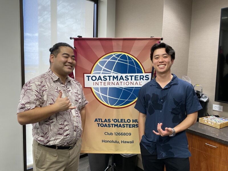 Smiling Atlas Insurance workers at a Toastmasters Meeting