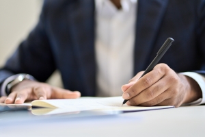 Businessman Maintaining Insurance Claim Journal