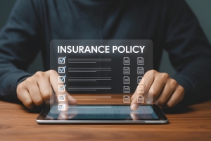 Businessman Reviewing Insurance Policy Details on Digital Tablet