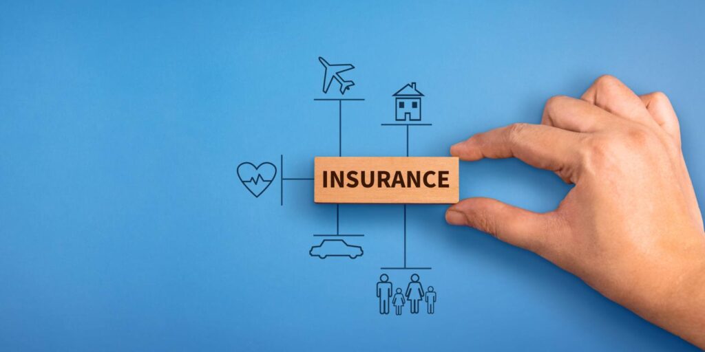 Hand Holding A Wooden Block with Text Insurance