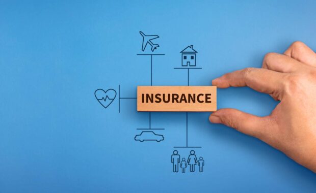 Hand Holding A Wooden Block with Text Insurance