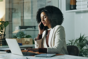 Non-Profit Business Woman Working on Laptop while Talking to Insurance Agent