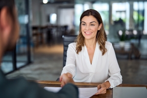 Smiling Business Woman Shaking Hand with Insurance Agent