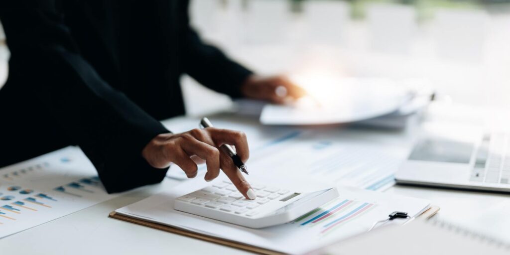 Non-Profit Business Owner Calculating Insurance Adjustment Cost