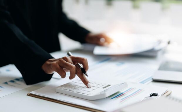 Non-Profit Business Owner Calculating Insurance Adjustment Cost