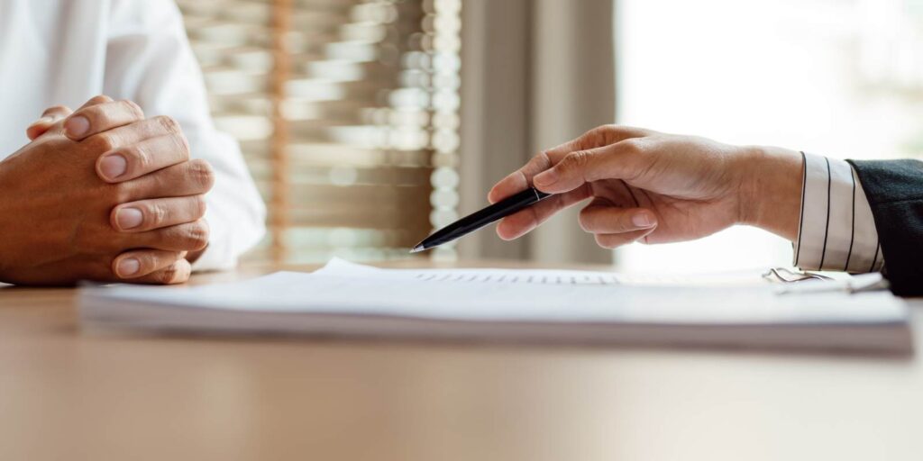 Agent Explaining Nonprofit Insurance Policy Features to Business Owner