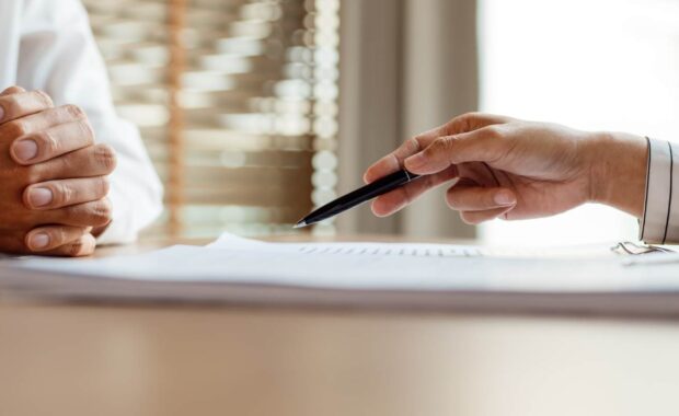 Agent Explaining Nonprofit Insurance Policy Features to Business Owner