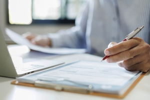 Nonprofit Business Owner Reviewing Documents to Understand Need of Insurance