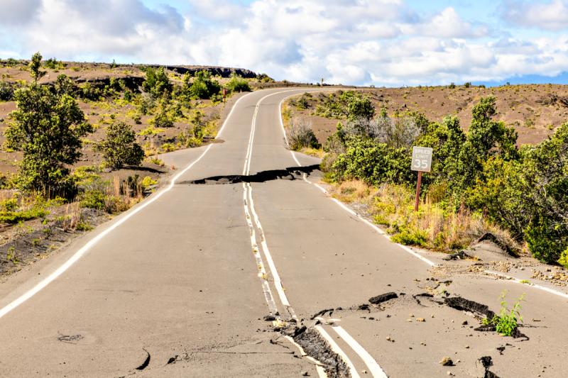 Damaged asphalt road Crater Rim Drive in the Hawaii Volcanoes National Park after earthquake and eruption of Kilauea