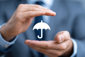 Hands Holding Small Umbrella Representing Insurance Coverage