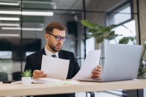 Businessman Reviewing Alternative Healthcare Funding Options in Office