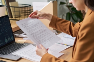 Businesswoman Reading Hawaiʻi Group Health Insurance Regulations Document