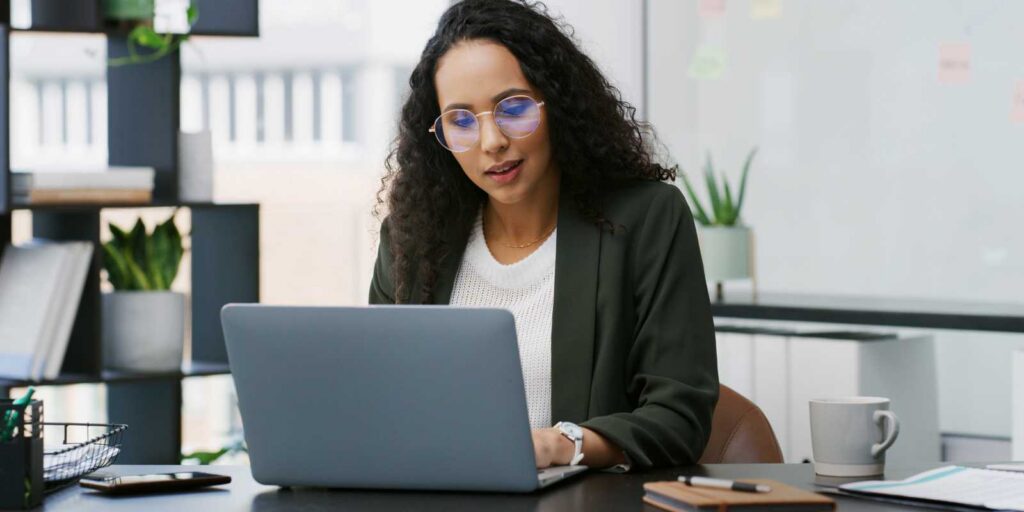 Businesswoman Watching Employee Benefits Trends on Her Laptop