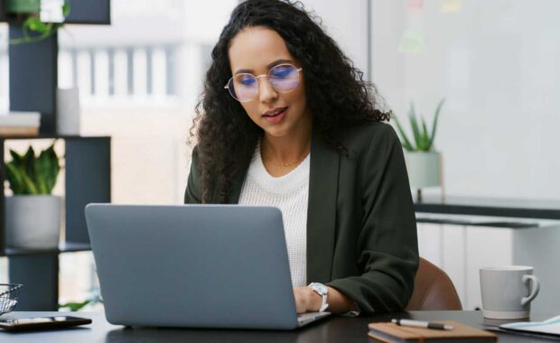Businesswoman Watching Employee Benefits Trends on Her Laptop